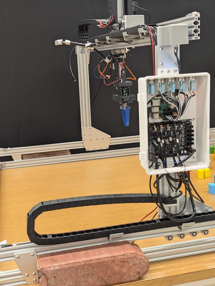 The open controller enclosure and wiring on the gantry.