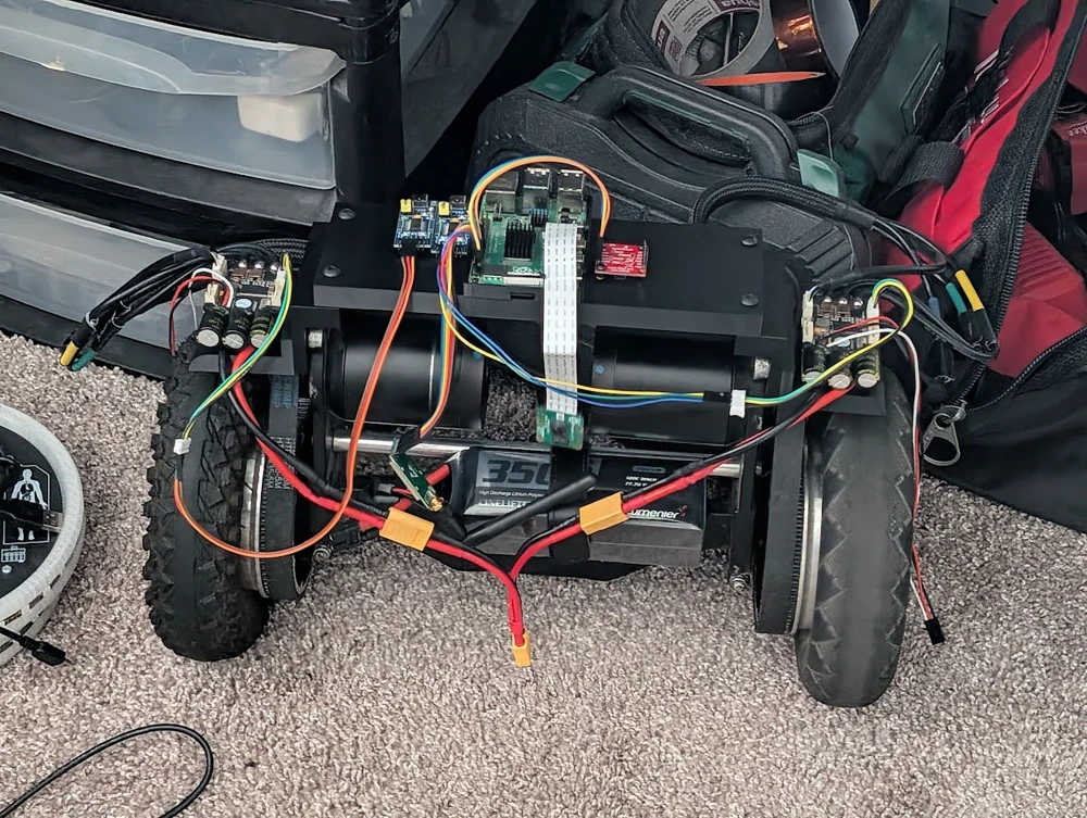 Rover electronics, motor controllers, and battery wiring across the chassis.