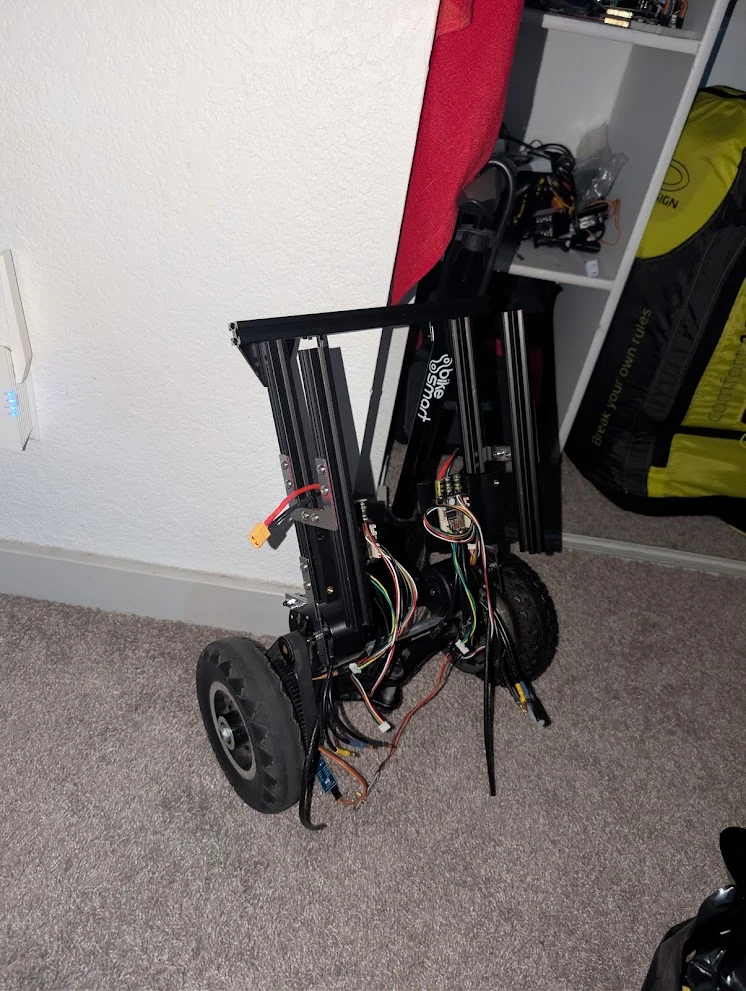 The upright rover frame, wheels, and exposed wiring during assembly.