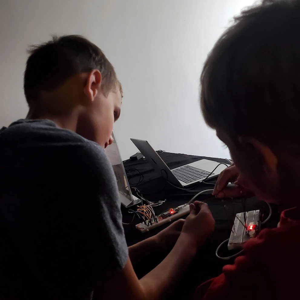 Trying out circuits together during an electronics activity.