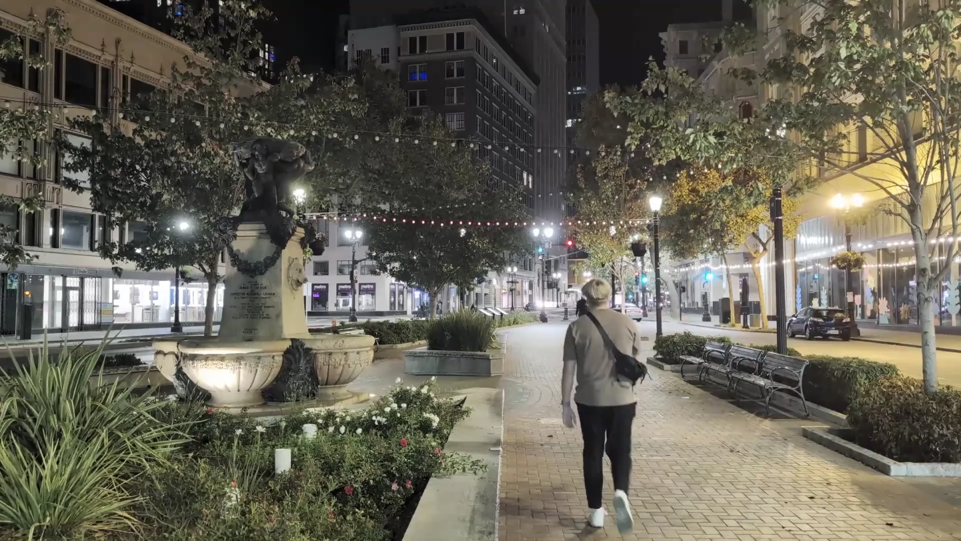 Me walking through a tree-lined city street at night during IYKYD.