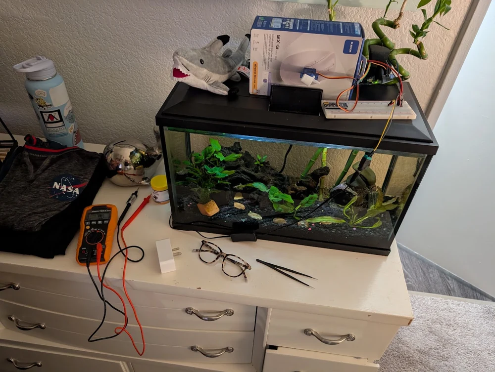An early Sync Tank aquarium with breadboard electronics and a small display.