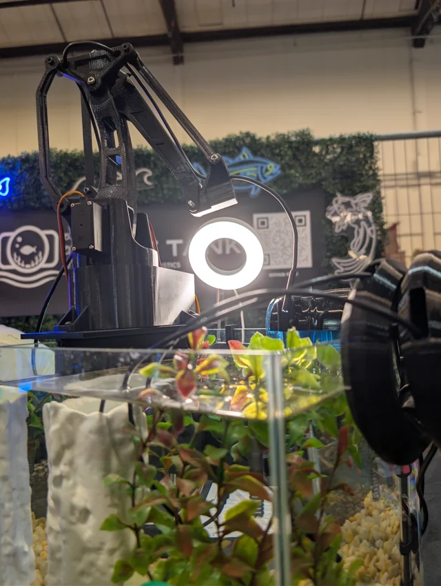 The articulated camera arm and ring light above the aquarium.